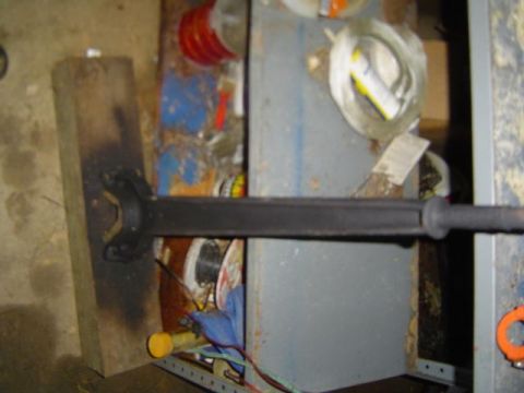 1979 Ford Bronco - A driveshaft part is shown in a cluttered workshop environment.