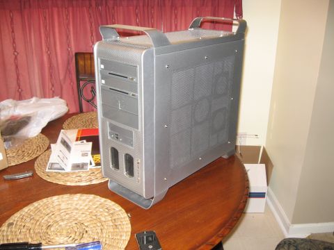 1988 Ford Bronco - A computer tower sits on a table, with various items scattered around it.