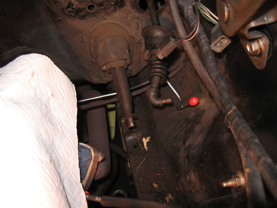 Automotive steering column and brake components with a white cloth covering part of the assembly