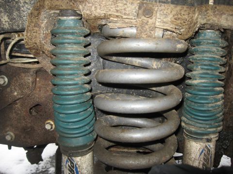 1996 Ford Bronco - Front suspension components, including coil springs and shock absorbers with protective boots, are shown in this close-up view.
