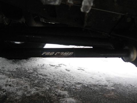 1996 Ford Bronco - Close-up of a Pro Comp suspension component, likely a shock absorber or linkage.