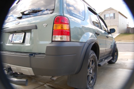 2006 Ford Escape - This 2006 Ford Escape is seen from the rear, aftermarket wheels and a tow hitch.