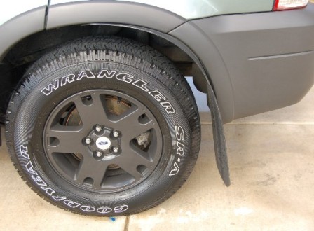 2006 Ford Escape - Rear wheel and fender detail of a 2006 Ford Escape.