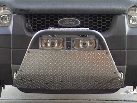 2006 Ford Escape - The front of a 2006 Ford Escape SUV is shown with a custom diamond plate bumper and fog lights.