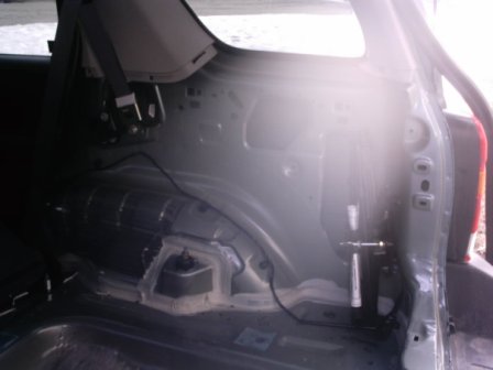 2006 Ford Escape - Interior view of the cargo area of a 2006 Ford Escape, revealing structural components.