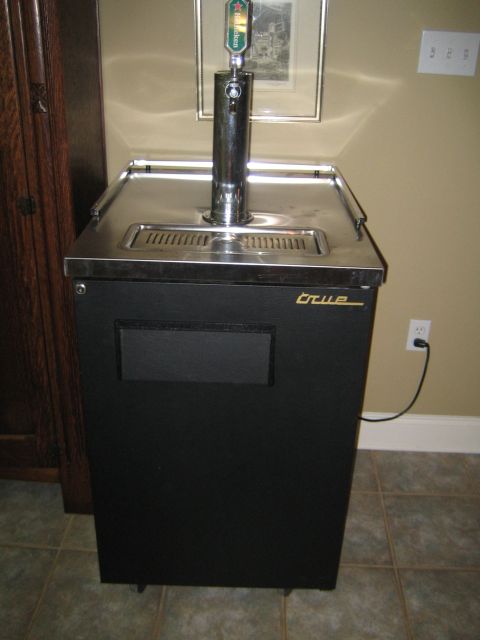 1995 Ford Bronco - A black kegerator with a chrome beer tap and a Heineken handle is shown with a gold 'True' logo.