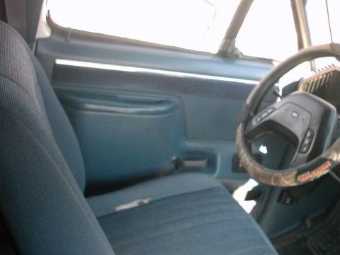 1987 Ford Bronco - Interior view of a 1987 Ford Bronco, blue cloth seats and the dashboard.