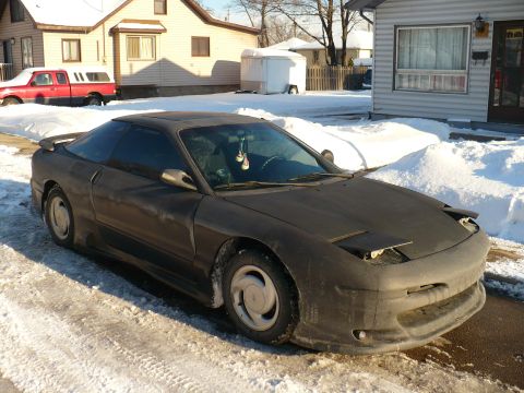 1993 Ford Probe - This 1993 Ford Probe is parked on a snowy street in front of a house.