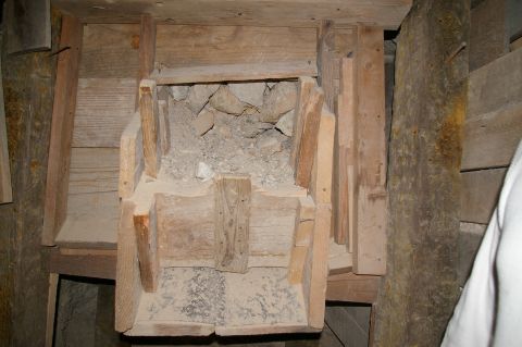 1986 Ford Bronco - A wooden chute designed to transport ore, constructed with rough-hewn planks and beams within a mine.