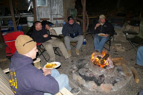 1986 Ford Bronco - Campfire gathering with friends enjoying food and conversation outdoors.