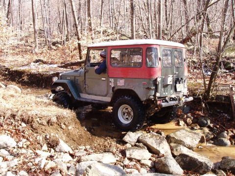 1976 Toyota Land Cruiser - This 1976 Toyota Land Cruiser navigates a challenging off-road course with water and rocks.