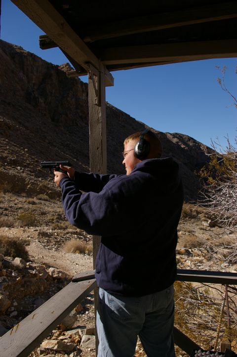 1986 Ford Bronco - Shooting practice at an outdoor range with mountains in the distance.