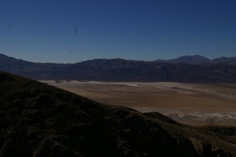 1986 Ford Bronco - Expansive desert landscape with mountains in the background and a dry lake bed in the foreground.