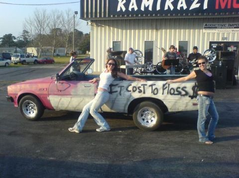 1981 Dodge Power Ram - A band performs behind a customized pickup truck with a message spray-painted on its side.