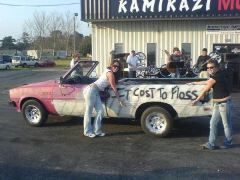 1981 Dodge Power Ram - A 1981 Dodge Power Ram pickup truck with graffiti on the side is shown with two women posing in front of a building.