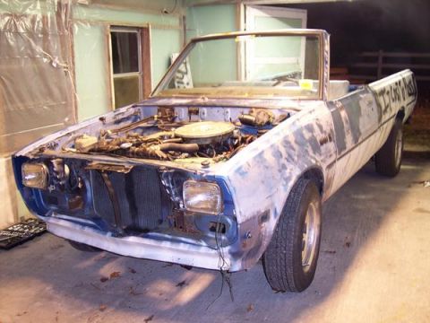 1981 Dodge Power Ram - This convertible pickup truck is in primer and has its hood open, revealing the engine bay.