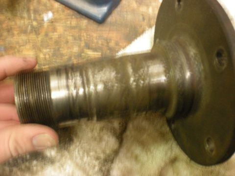 1993 Ford Bronco - Metal part with threads and a flange, likely a component from a vehicle.