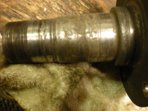 1993 Ford Bronco - This is a close-up view of a vehicle's wheel hub spindle, showing threads and signs of wear.