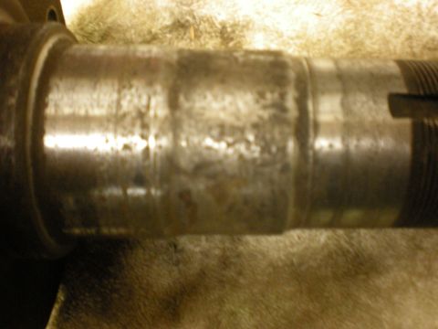 1993 Ford Bronco - Close-up of a worn metal shaft, likely a component from machinery or a vehicle part.