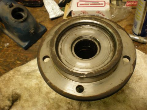 1993 Ford Bronco - A worn wheel bearing hub assembly sits on a rag, with tools and boxes in the background.