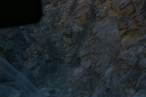 1986 Ford Bronco - A view of a rocky cliff face, likely taken from a vehicle.