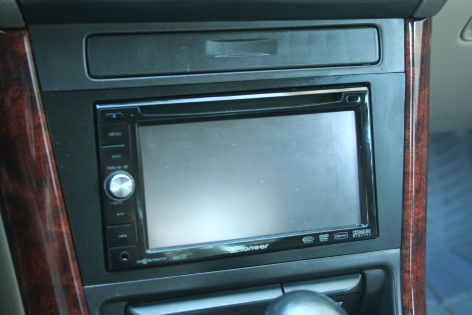 Pioneer double-DIN touchscreen head unit in center stack with wood trim surround