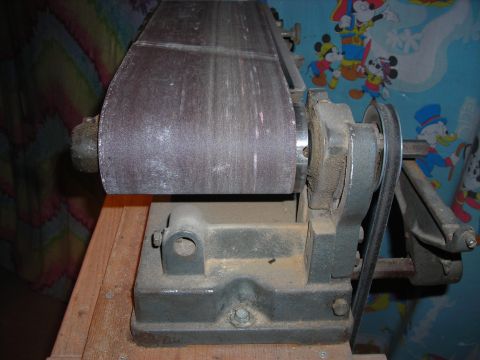 1995 Ford Bronco - Close-up of a belt sander, a shop tool, with a worn sanding belt.