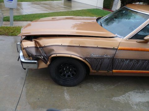 1975 Ford Ranchero - This Ford Ranchero Squire has significant front-end damage, particularly to the fender and bumper area.