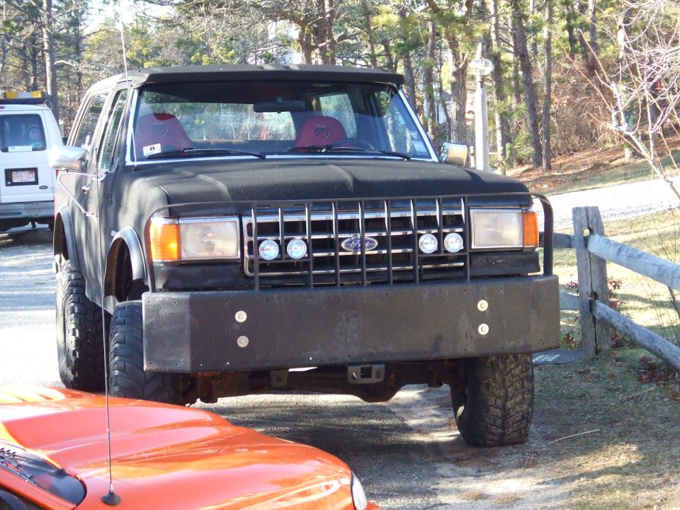 Black SUV front view with custom bumper and off-road tires
