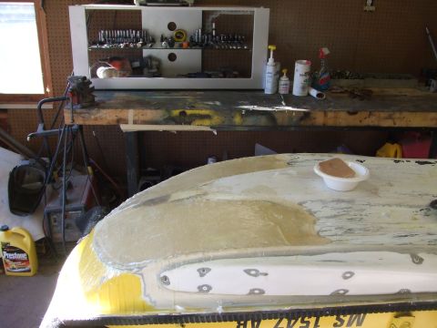 1998 Kawasaki JH1100-A4 1100 ZXi - Jet ski hull repair in progress, showing fiberglass work and filler application. Workbench with tools in background.
