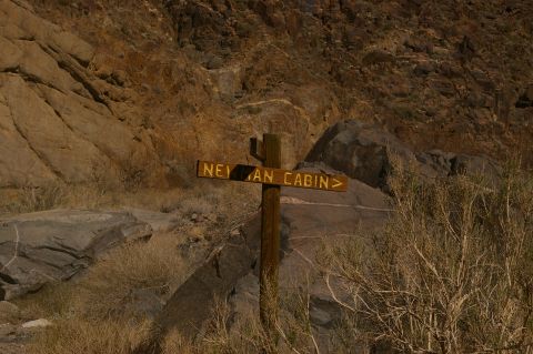1986 Ford Bronco - Signpost indicates the direction to Neyman Cabin in a rocky, arid environment.
