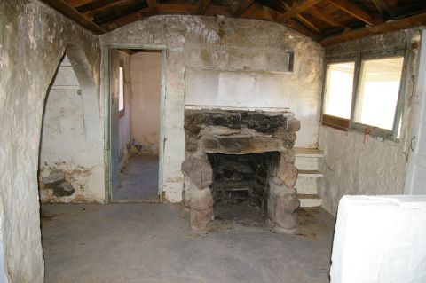 1986 Ford Bronco - Rustic cabin interior with a stone fireplace and rough-hewn walls.