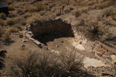 1986 Ford Bronco - Remnants of a stone structure stand in a desolate, arid environment, suggesting a historical settlement.