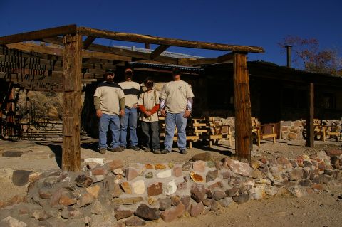 1986 Ford Bronco - A group of men pose for a photo outside a weathered building with a covered patio.