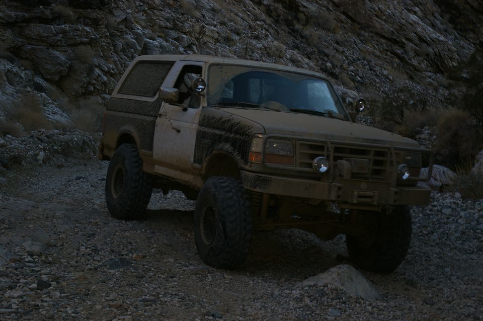 Muddy Ford Bronco on rocky terrain