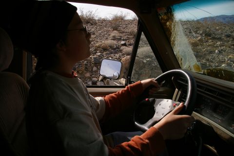 1986 Ford Bronco - Driving a 1986 Ford Bronco through a rocky, desert terrain with a cracked windshield.