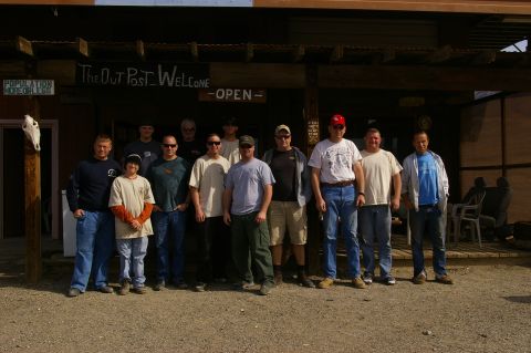 1986 Ford Bronco - A group of men pose for a photo outside "The Out Post" building, which has a sign reading "Welcome - Open".