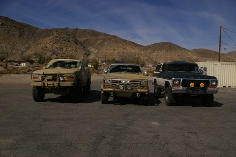 1986 Ford Bronco - Three SUVs parked in a desert landscape. The rightmost vehicle is a 1978 Ford Bronco.