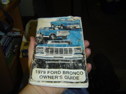 1979 Ford Bronco - A worn owner's guide document displays illustrations of blue Ford Broncos from different angles.