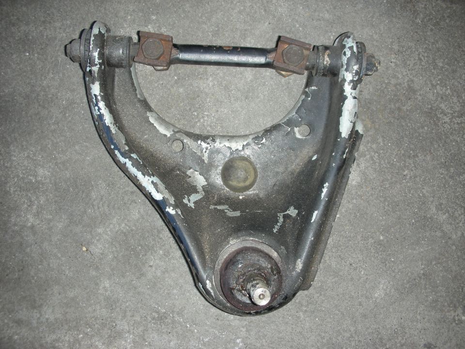 Weathered control arm with worn paint, ball joint and pivot shaft