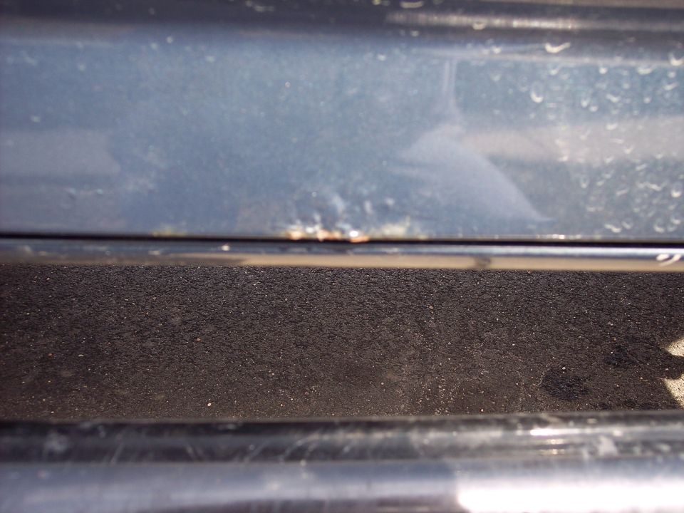 Small rust spot at bottom of passenger door.