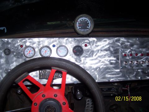 1978 Ford Bronco - Interior view of a vehicle's custom dashboard with a red steering wheel and various gauges.