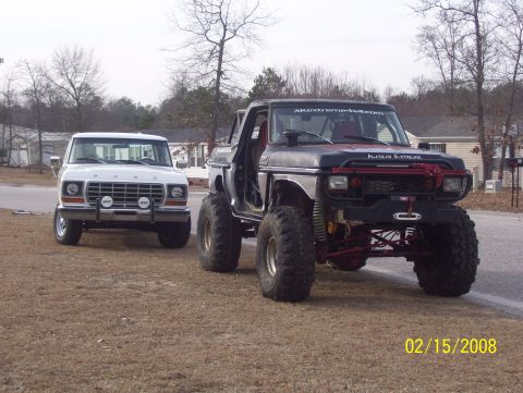 1978 Ford Bronco - Two Ford trucks are parked on a dirt road, one is a 1978 Bronco and the other is heavily modified.