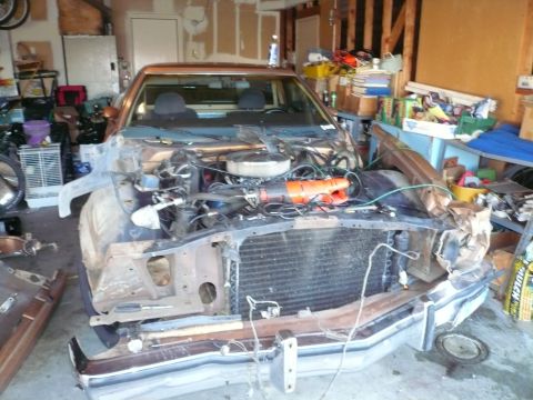 1975 Ford Ranchero - This 1975 Ford Ranchero is in a state of disassembly, with its front end removed and engine exposed.