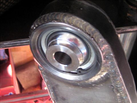 1996 Ford Bronco - A detailed view of a vehicle's suspension component, highlighting the bearing and surrounding metalwork.