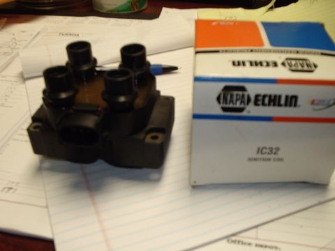 1996 Ford Crown Victoria - A NAPA Echlin IC32 ignition coil is shown next to its product box, resting on papers.