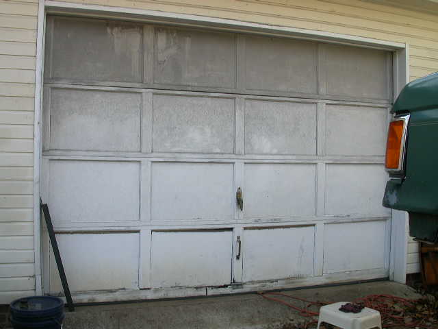 Old, crappy, wood & MDF, rotten along the bottom garage door.