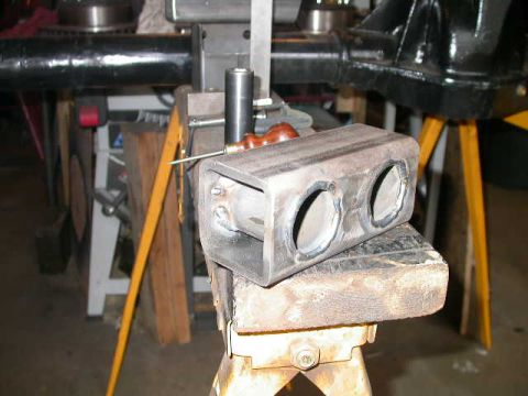 1990 Ford Bronco - Fabricated metal bracket with dual openings, likely for automotive modification.