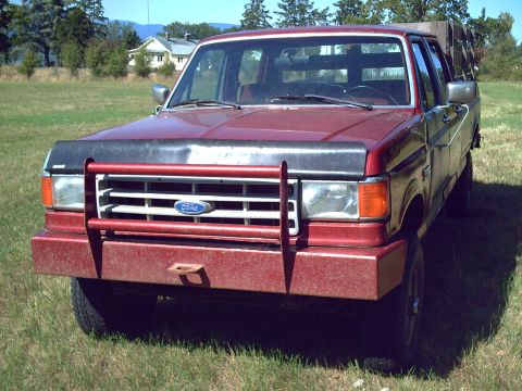 1991 Ford F-350 - This red 1991 Ford F-350 pickup truck is seen from the front, equipped with a brush guard.