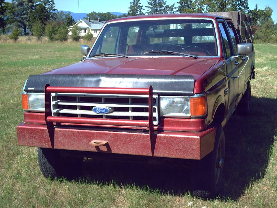 Red 1991 Ford F-350 front view with brush guard